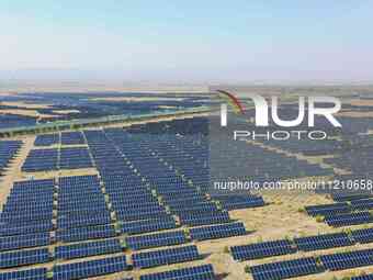 A drone is capturing images of photovoltaic power stations on both sides of the Beijing-Wei Expressway in Zhangjiakou, Hebei Province, China...