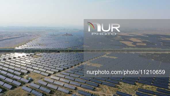 A drone is capturing images of photovoltaic power stations on both sides of the Beijing-Wei Expressway in Zhangjiakou, Hebei Province, China...