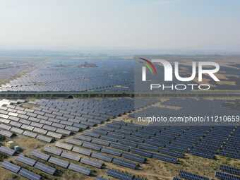 A drone is capturing images of photovoltaic power stations on both sides of the Beijing-Wei Expressway in Zhangjiakou, Hebei Province, China...