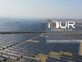 A drone is capturing images of photovoltaic power stations on both sides of the Beijing-Wei Expressway in Zhangjiakou, Hebei Province, China...