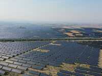 A drone is capturing images of photovoltaic power stations on both sides of the Beijing-Wei Expressway in Zhangjiakou, Hebei Province, China...