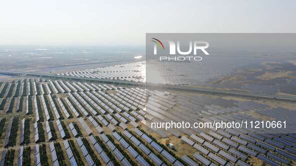 A drone is capturing images of photovoltaic power stations on both sides of the Beijing-Wei Expressway in Zhangjiakou, Hebei Province, China...