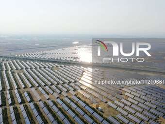 A drone is capturing images of photovoltaic power stations on both sides of the Beijing-Wei Expressway in Zhangjiakou, Hebei Province, China...