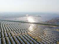 A drone is capturing images of photovoltaic power stations on both sides of the Beijing-Wei Expressway in Zhangjiakou, Hebei Province, China...