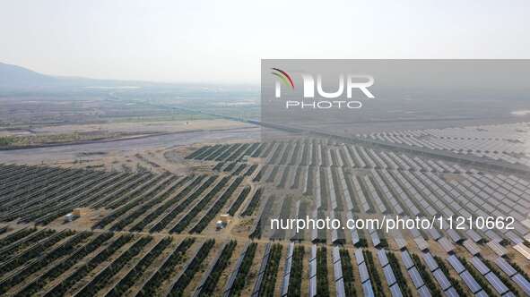 A drone is capturing images of photovoltaic power stations on both sides of the Beijing-Wei Expressway in Zhangjiakou, Hebei Province, China...