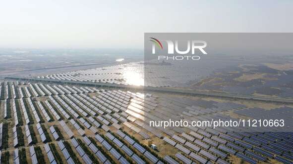 A drone is capturing images of photovoltaic power stations on both sides of the Beijing-Wei Expressway in Zhangjiakou, Hebei Province, China...