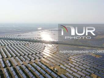 A drone is capturing images of photovoltaic power stations on both sides of the Beijing-Wei Expressway in Zhangjiakou, Hebei Province, China...