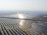 A drone is capturing images of photovoltaic power stations on both sides of the Beijing-Wei Expressway in Zhangjiakou, Hebei Province, China...