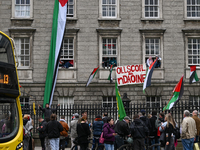 DUBLIN, IRELAND - MAY 4:
Trinity College Dublin windows occupied by students in Keffiyeh and face masks, waving Palestinian flags, on May 4,...