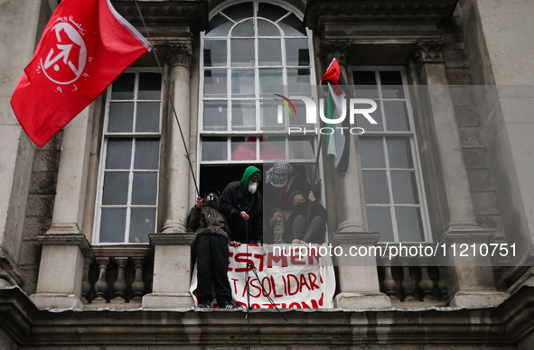 DUBLIN, IRELAND - MAY 4:
Trinity College Dublin windows occupied by students in Keffiyeh and face masks, waving Palestinian flags, on May 4,...