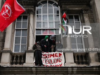 DUBLIN, IRELAND - MAY 4:
Trinity College Dublin windows occupied by students in Keffiyeh and face masks, waving Palestinian flags, on May 4,...