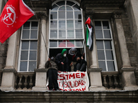 DUBLIN, IRELAND - MAY 4:
Trinity College Dublin windows occupied by students in Keffiyeh and face masks, waving Palestinian flags, on May 4,...