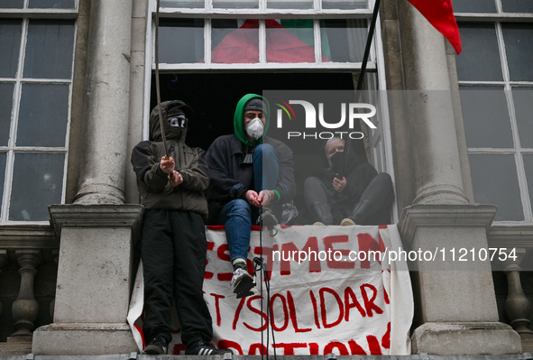 DUBLIN, IRELAND - MAY 4:
Trinity College Dublin windows occupied by students in Keffiyeh and face masks, waving Palestinian flags, on May 4,...