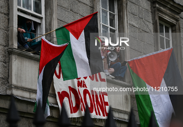 DUBLIN, IRELAND - MAY 4:
Trinity College Dublin windows occupied by students in Keffiyeh and face masks, waving Palestinian flags, on May 4,...