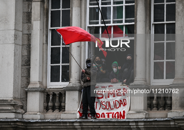 DUBLIN, IRELAND - MAY 4:
Trinity College Dublin windows occupied by students in Keffiyeh and face masks, waving Palestinian flags, on May 4,...