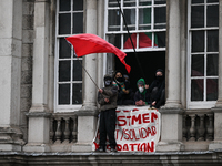 DUBLIN, IRELAND - MAY 4:
Trinity College Dublin windows occupied by students in Keffiyeh and face masks, waving Palestinian flags, on May 4,...