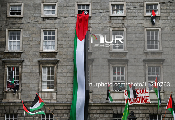 DUBLIN, IRELAND - MAY 4:
Trinity College Dublin windows occupied by students in Keffiyeh and face masks, waving Palestinian flags, on May 4,...