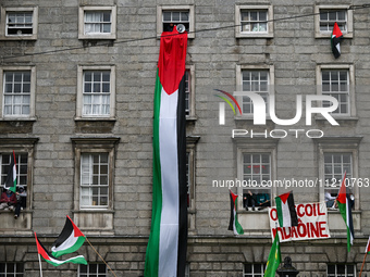 DUBLIN, IRELAND - MAY 4:
Trinity College Dublin windows occupied by students in Keffiyeh and face masks, waving Palestinian flags, on May 4,...