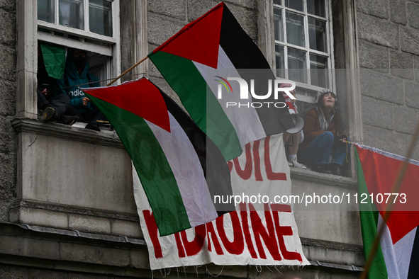 DUBLIN, IRELAND - MAY 4:
Trinity College Dublin windows occupied by students in Keffiyeh and face masks, waving Palestinian flags, on May 4,...