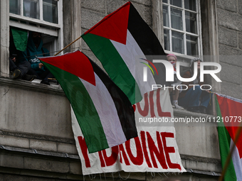 DUBLIN, IRELAND - MAY 4:
Trinity College Dublin windows occupied by students in Keffiyeh and face masks, waving Palestinian flags, on May 4,...