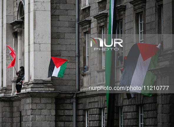 DUBLIN, IRELAND - MAY 4:
Trinity College Dublin windows occupied by students in Keffiyeh and face masks, waving Palestinian flags, on May 4,...