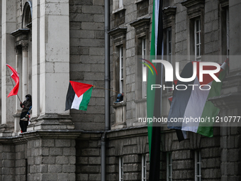 DUBLIN, IRELAND - MAY 4:
Trinity College Dublin windows occupied by students in Keffiyeh and face masks, waving Palestinian flags, on May 4,...