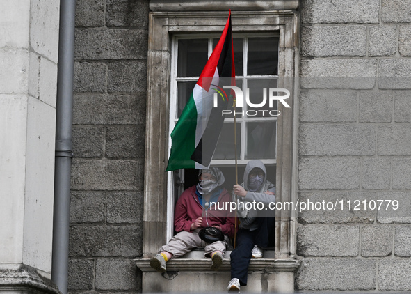 DUBLIN, IRELAND - MAY 4:
Trinity College Dublin windows occupied by students in Keffiyeh and face masks, waving Palestinian flags, on May 4,...