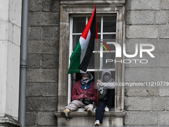 DUBLIN, IRELAND - MAY 4:
Trinity College Dublin windows occupied by students in Keffiyeh and face masks, waving Palestinian flags, on May 4,...