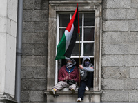 DUBLIN, IRELAND - MAY 4:
Trinity College Dublin windows occupied by students in Keffiyeh and face masks, waving Palestinian flags, on May 4,...