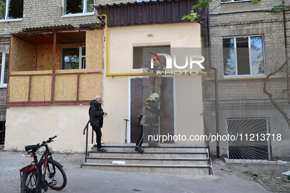 Rescuers are working at an apartment block that was damaged by Russian shelling in Kharkiv, northeastern Ukraine, on May 5, 2024. 