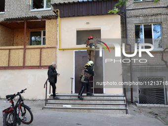 Rescuers are working at an apartment block that was damaged by Russian shelling in Kharkiv, northeastern Ukraine, on May 5, 2024. (