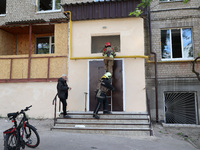 Rescuers are working at an apartment block that was damaged by Russian shelling in Kharkiv, northeastern Ukraine, on May 5, 2024. (