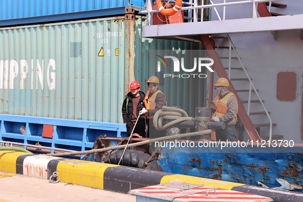 A worker is operating a machine at Taicang Port and the International Port to remove pollutants in Suzhou, Jiangsu Province, China, on March...