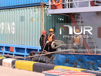 A worker is operating a machine at Taicang Port and the International Port to remove pollutants in Suzhou, Jiangsu Province, China, on March...