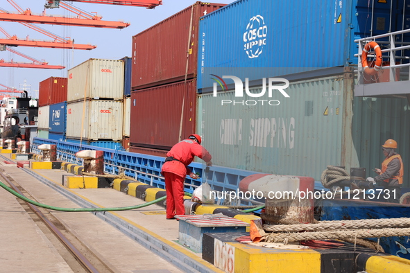 A worker is operating a machine at Taicang Port and the International Port to remove pollutants in Suzhou, Jiangsu Province, China, on March...