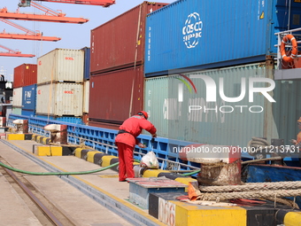 A worker is operating a machine at Taicang Port and the International Port to remove pollutants in Suzhou, Jiangsu Province, China, on March...