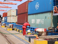 A worker is operating a machine at Taicang Port and the International Port to remove pollutants in Suzhou, Jiangsu Province, China, on March...