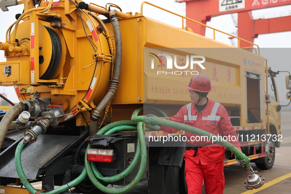 A worker is operating a machine at Taicang Port and the International Port to remove pollutants in Suzhou, Jiangsu Province, China, on March...