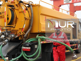 A worker is operating a machine at Taicang Port and the International Port to remove pollutants in Suzhou, Jiangsu Province, China, on March...