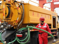 A worker is operating a machine at Taicang Port and the International Port to remove pollutants in Suzhou, Jiangsu Province, China, on March...