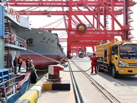 A worker is operating a machine at Taicang Port and the International Port to remove pollutants in Suzhou, Jiangsu Province, China, on March...