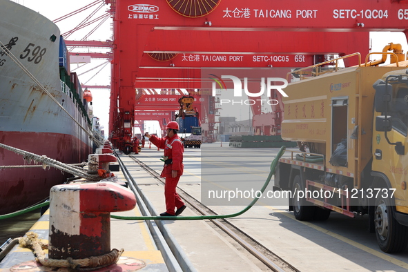 A worker is operating a machine at Taicang Port and the International Port to remove pollutants in Suzhou, Jiangsu Province, China, on March...