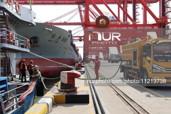 A worker is operating a machine at Taicang Port and the International Port to remove pollutants in Suzhou, Jiangsu Province, China, on March...