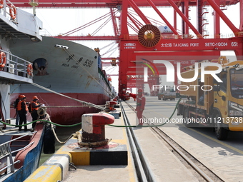 A worker is operating a machine at Taicang Port and the International Port to remove pollutants in Suzhou, Jiangsu Province, China, on March...