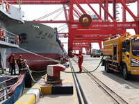 A worker is operating a machine at Taicang Port and the International Port to remove pollutants in Suzhou, Jiangsu Province, China, on March...