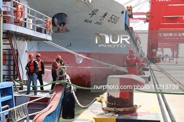 A worker is operating a machine at Taicang Port and the International Port to remove pollutants in Suzhou, Jiangsu Province, China, on March...