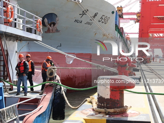 A worker is operating a machine at Taicang Port and the International Port to remove pollutants in Suzhou, Jiangsu Province, China, on March...