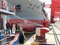 A worker is operating a machine at Taicang Port and the International Port to remove pollutants in Suzhou, Jiangsu Province, China, on March...