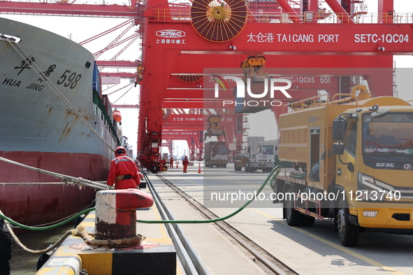 A worker is operating a machine at Taicang Port and the International Port to remove pollutants in Suzhou, Jiangsu Province, China, on March...