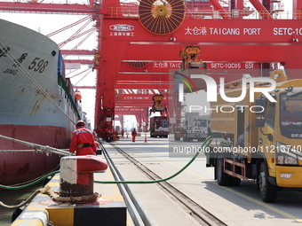 A worker is operating a machine at Taicang Port and the International Port to remove pollutants in Suzhou, Jiangsu Province, China, on March...